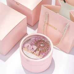 Pink jewelry box with a heart design and 'Forever Love' necklace on a white background