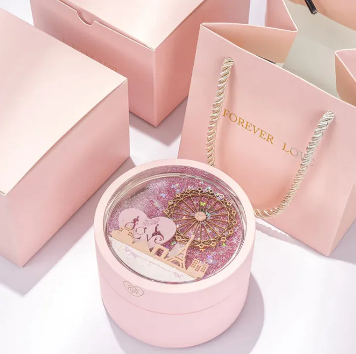 Pink jewelry box with a heart design and 'Forever Love' necklace on a white background